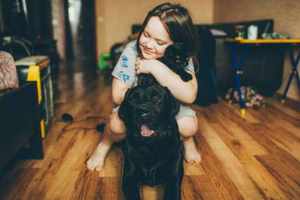A girl hugging her pet