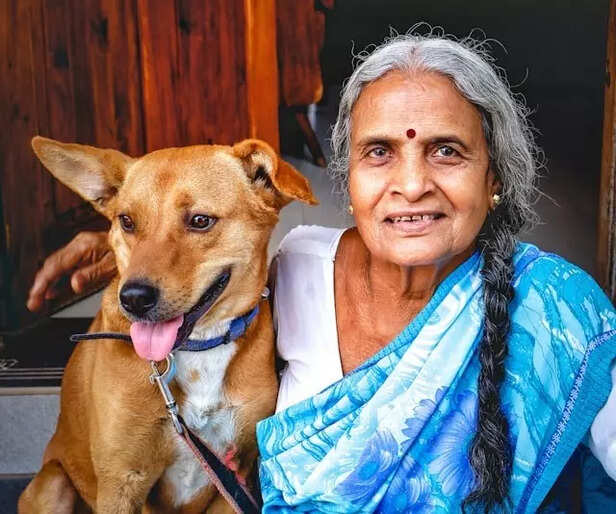 A dog sitting with an old