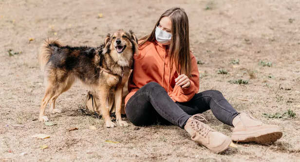 Woman Sitting With Her Newly Adopted Dog Outdoors